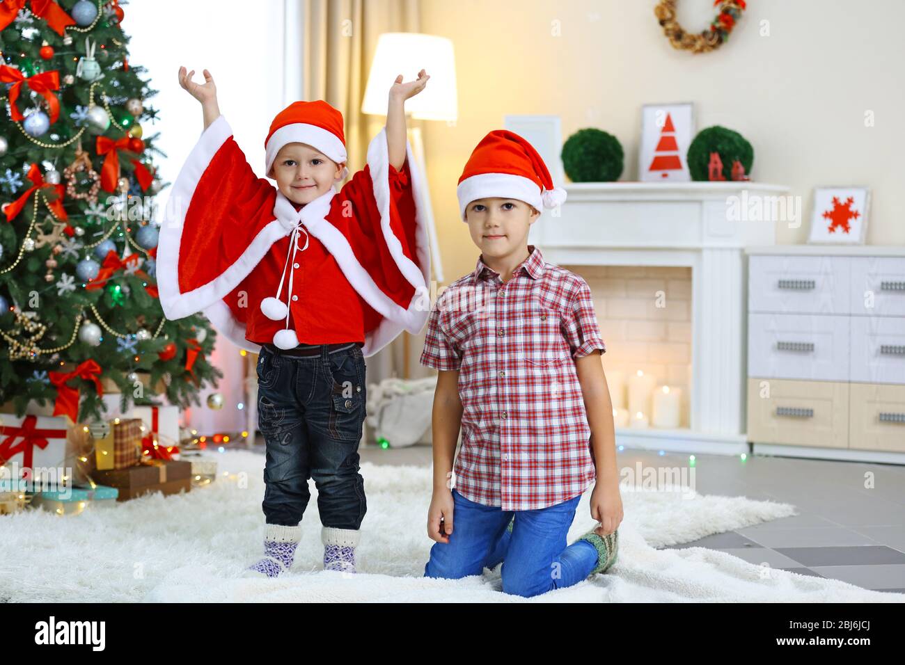 Two cute small brothers on Christmas decoration background Stock Photo ...