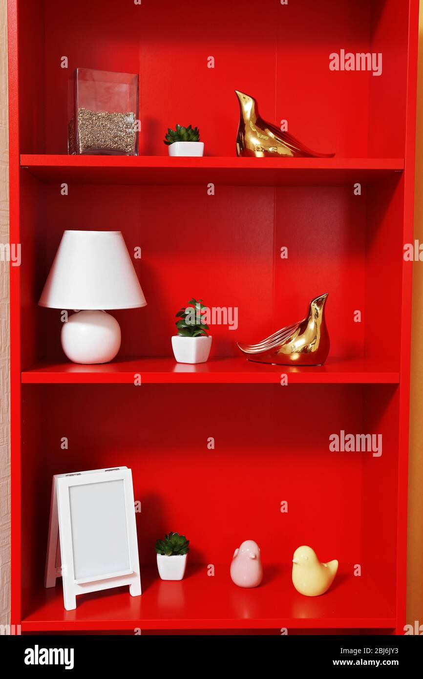 Red bookcase with white accessories, close up Stock Photo Alamy
