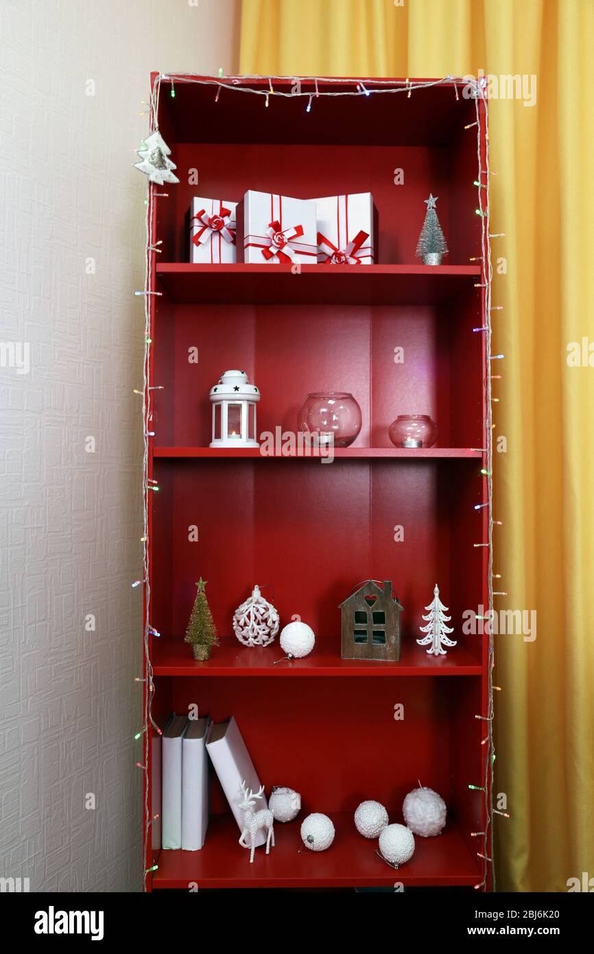 Red bookcase with white accessories, close up Stock Photo - Alamy