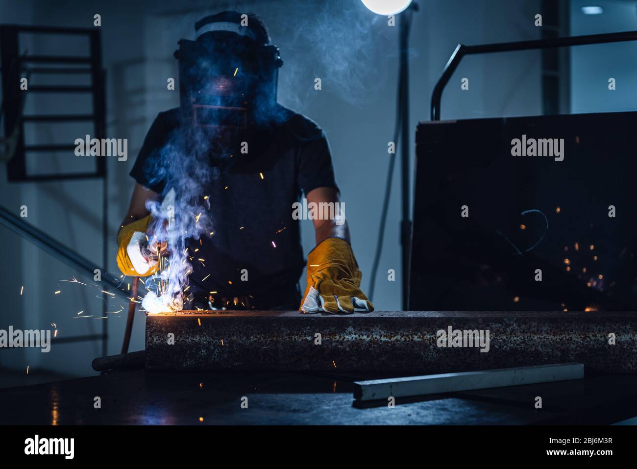 Welder Man is Welding Pipeline Fabrication Assembly in Workshop. Technician Welding in Safety Protective Equipment is Working Metalwork. Jobs Occupati Stock Photo