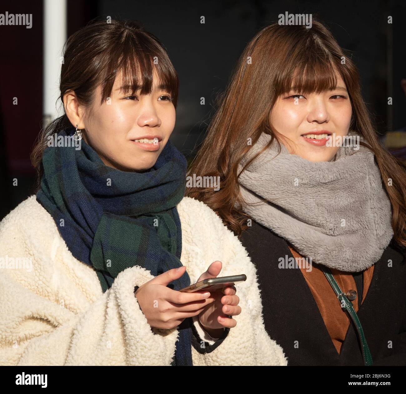 Two young Japanese women walking in oneo park, Tokyo, Japan Stock Photo