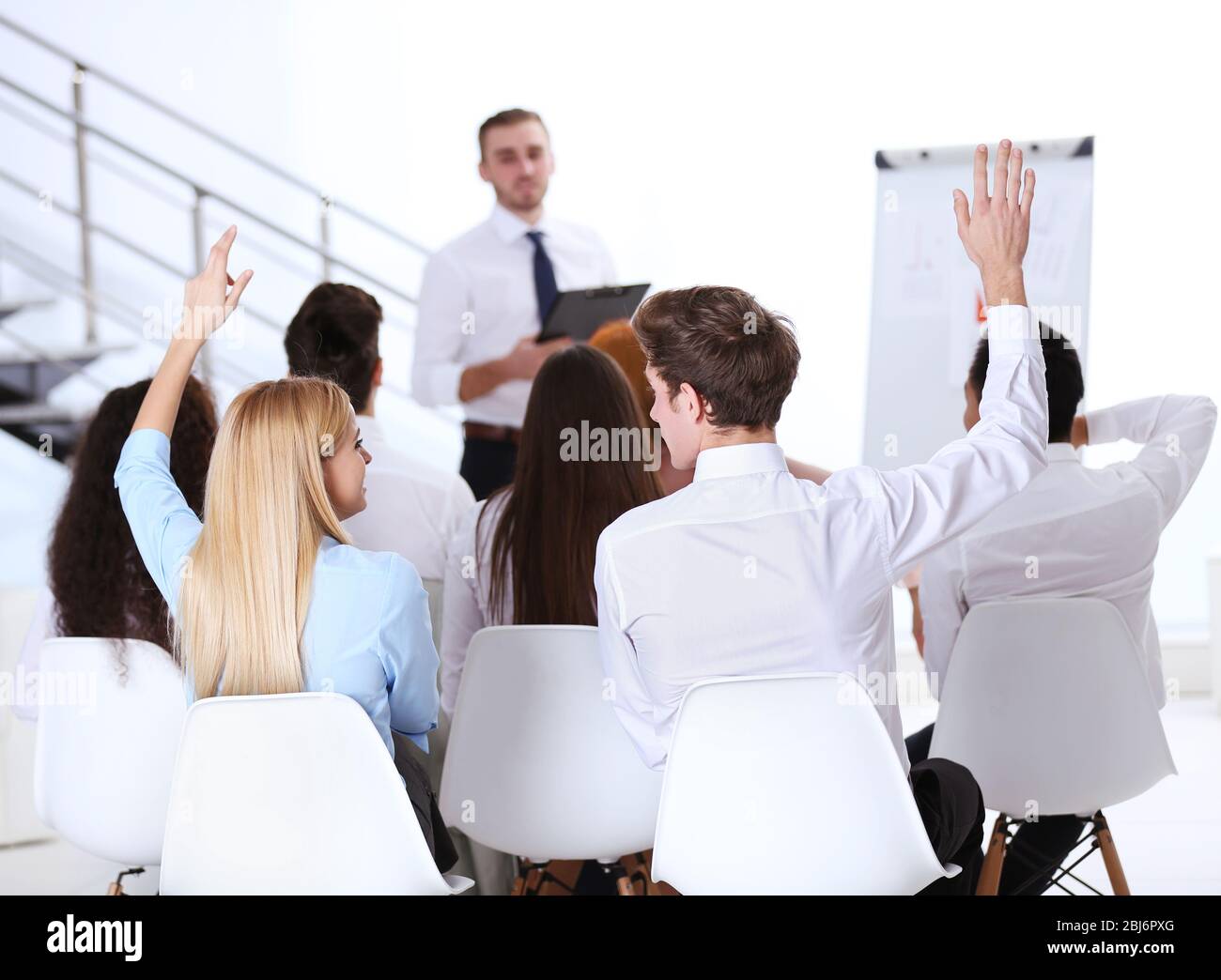 Business people raising hand voting hi-res stock photography and images ...