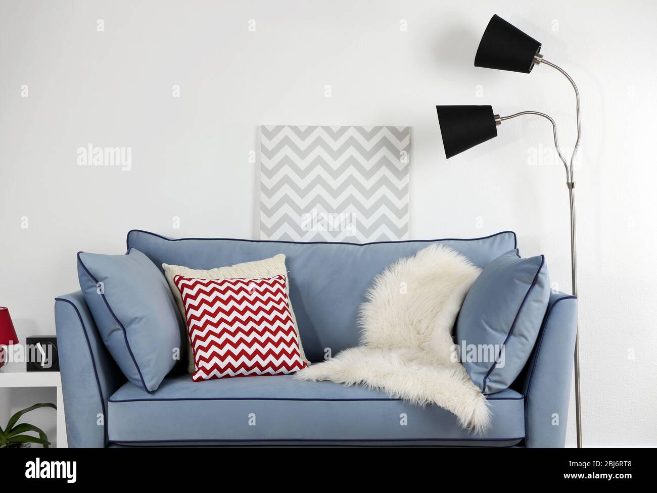 Beautiful modern living room with blue sofa and floor lamp Stock Photo ...