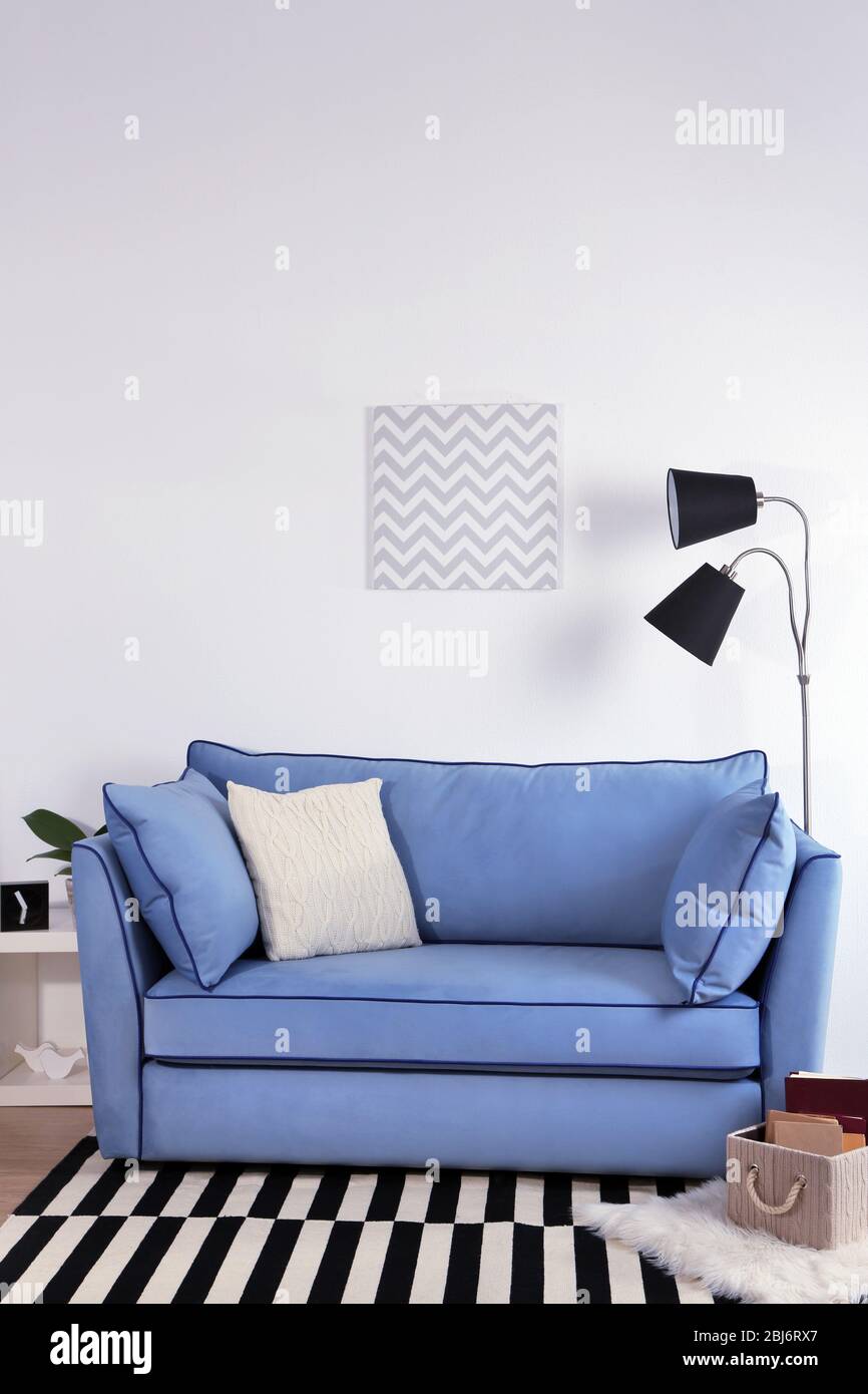Beautiful modern living room with blue sofa and floor lamp Stock Photo ...