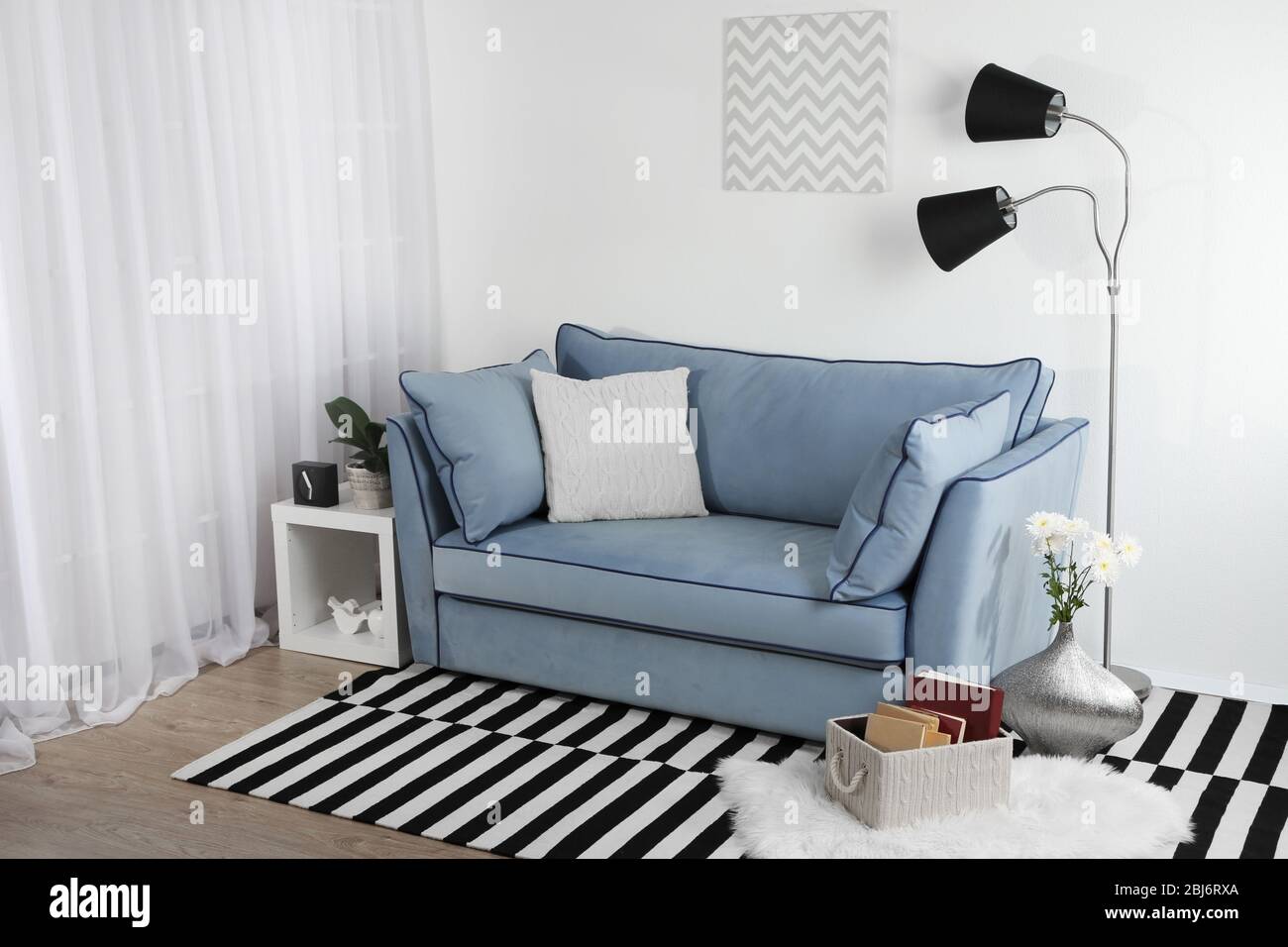 Beautiful modern living room with blue sofa and floor lamp Stock Photo ...