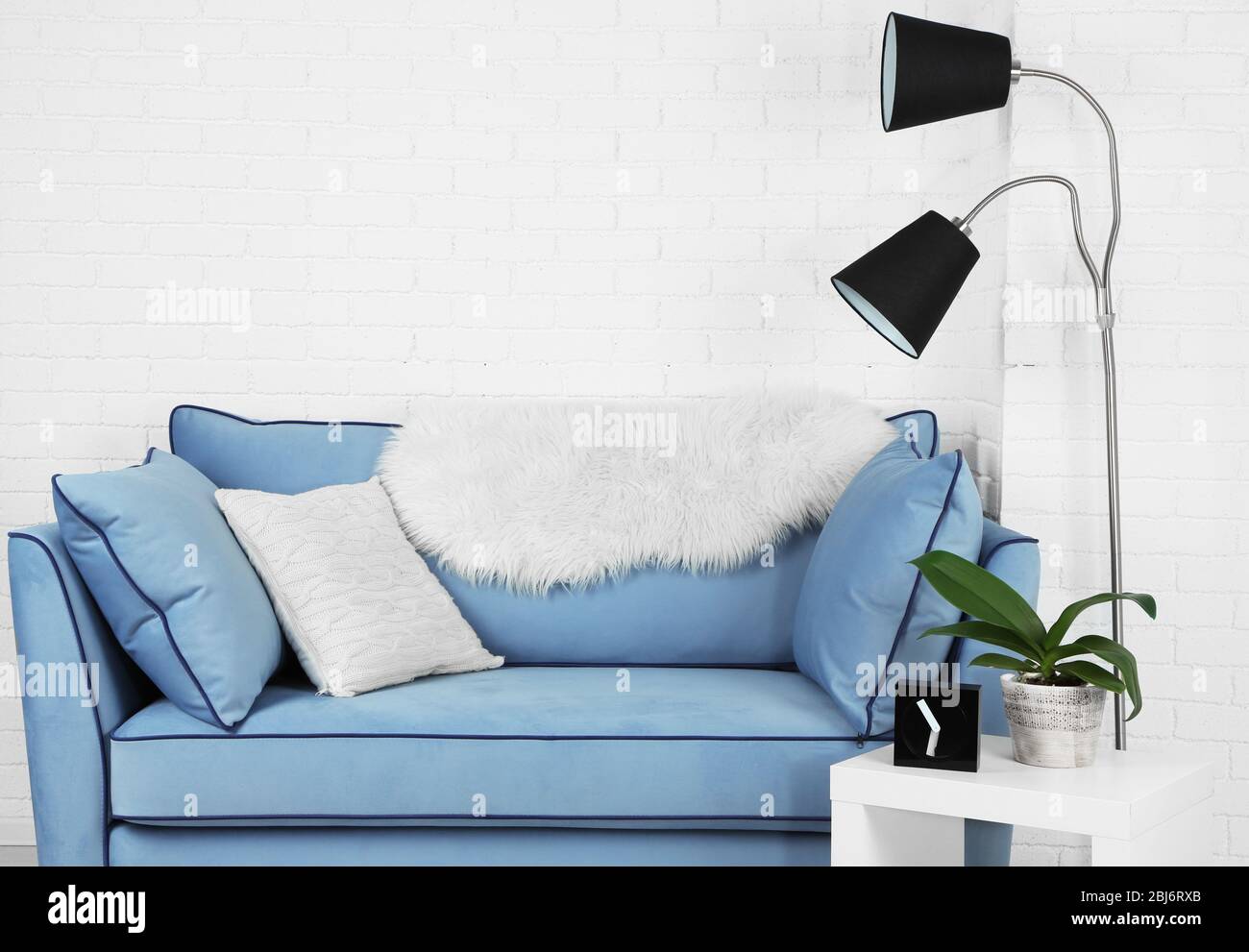 Beautiful modern living room with blue sofa and floor lamp Stock Photo ...