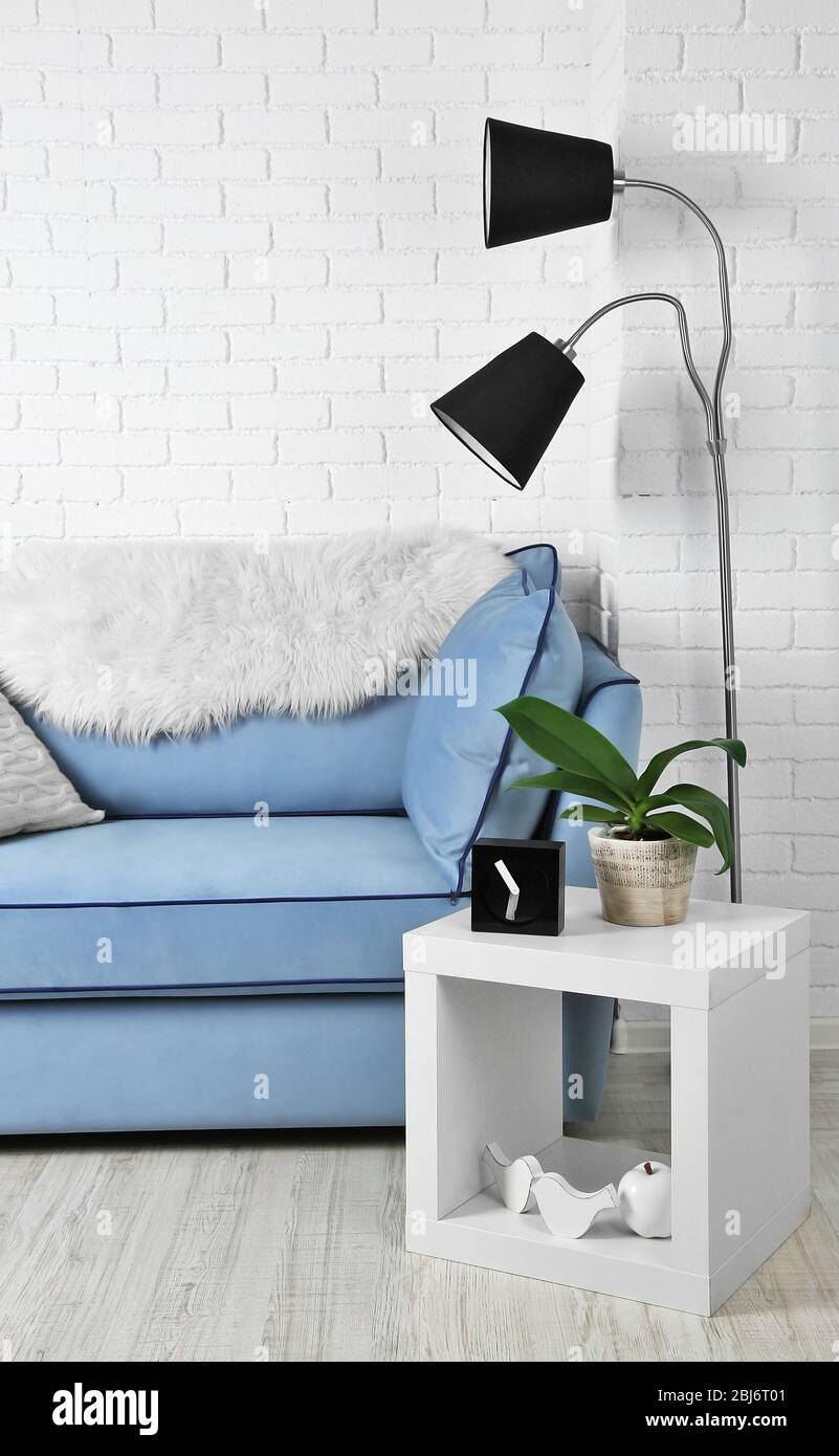Beautiful modern living room with blue sofa and floor lamp Stock Photo ...