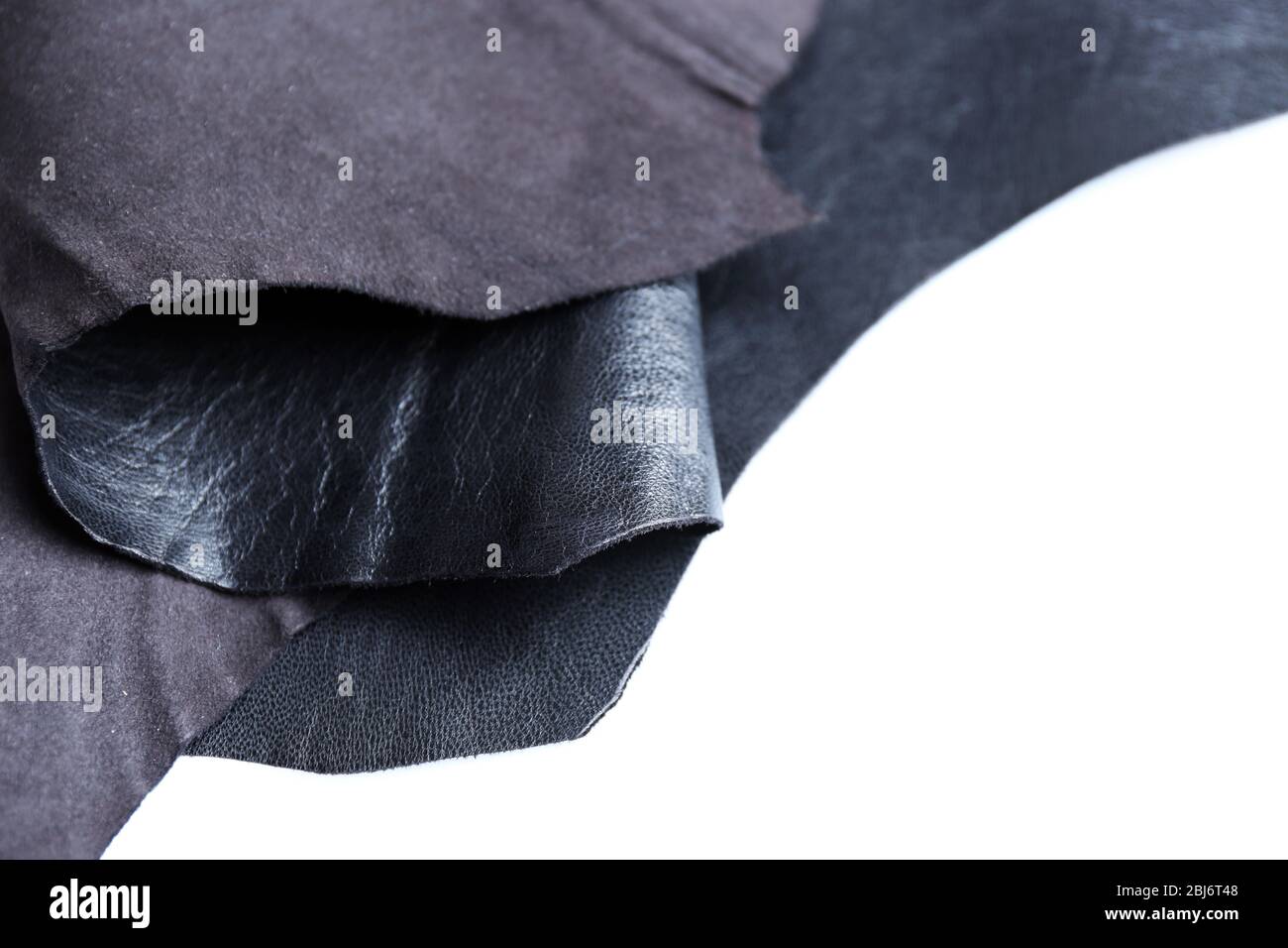 Black leather front and wrong side texture on white background, close-up Stock Photo