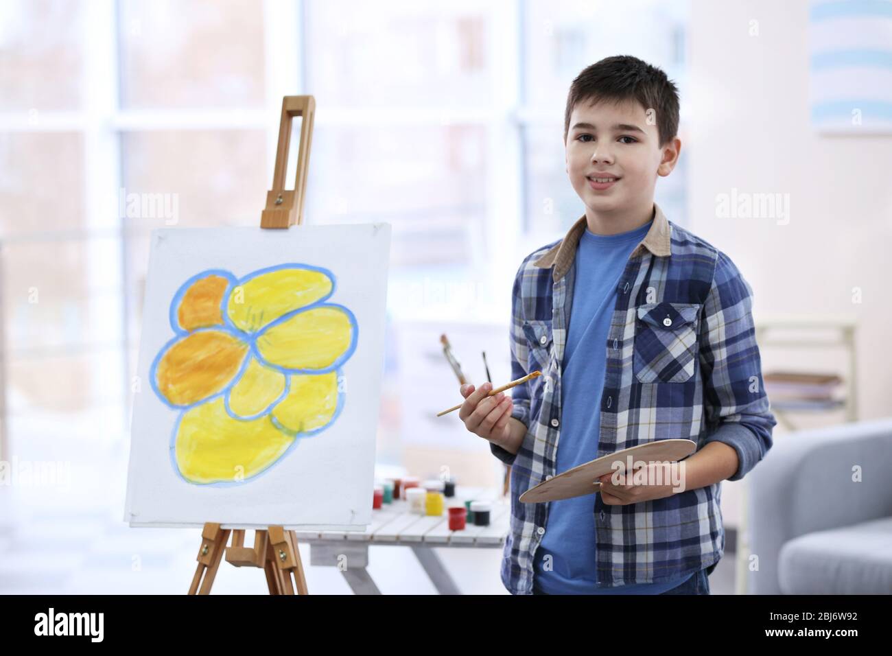 Little boy drawing on easel at home Stock Photo Alamy