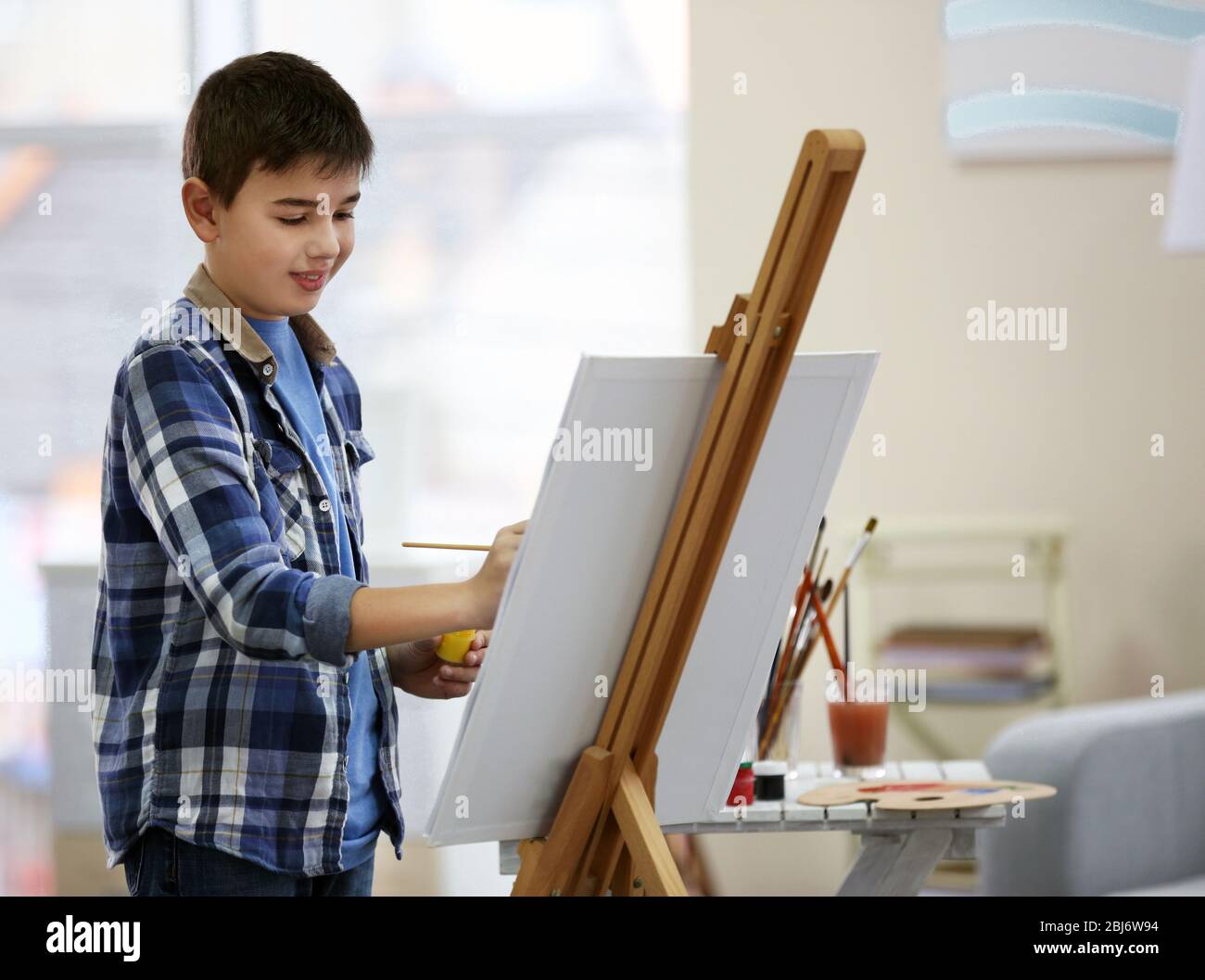 Little boy drawing on easel at home Stock Photo Alamy