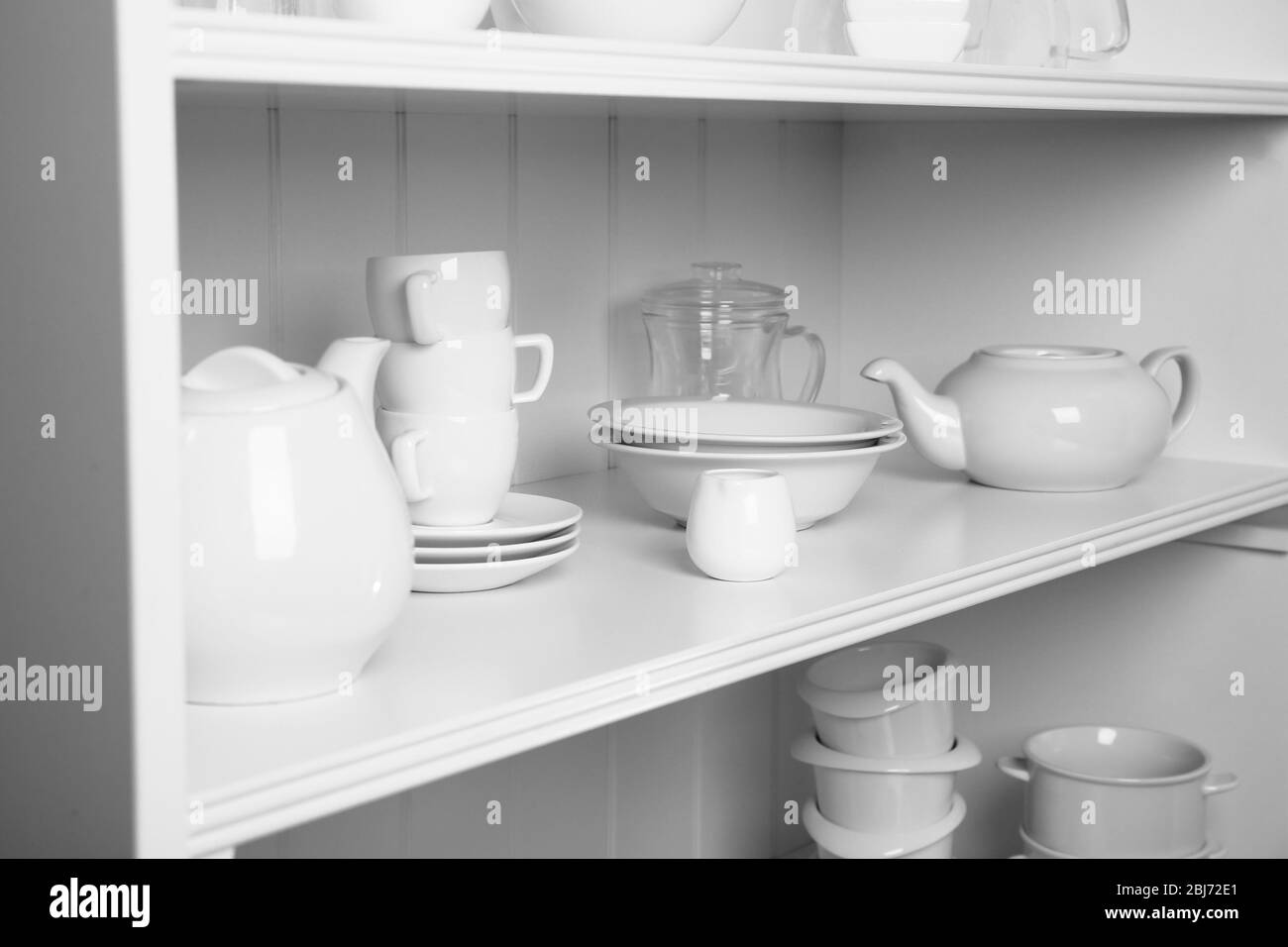 Dishes in cupboard in the kitchen Stock Photo Alamy