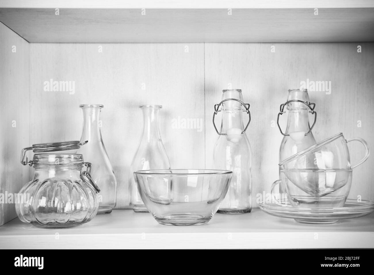 Glass dishes on shelf in the kitchen Stock Photo Alamy