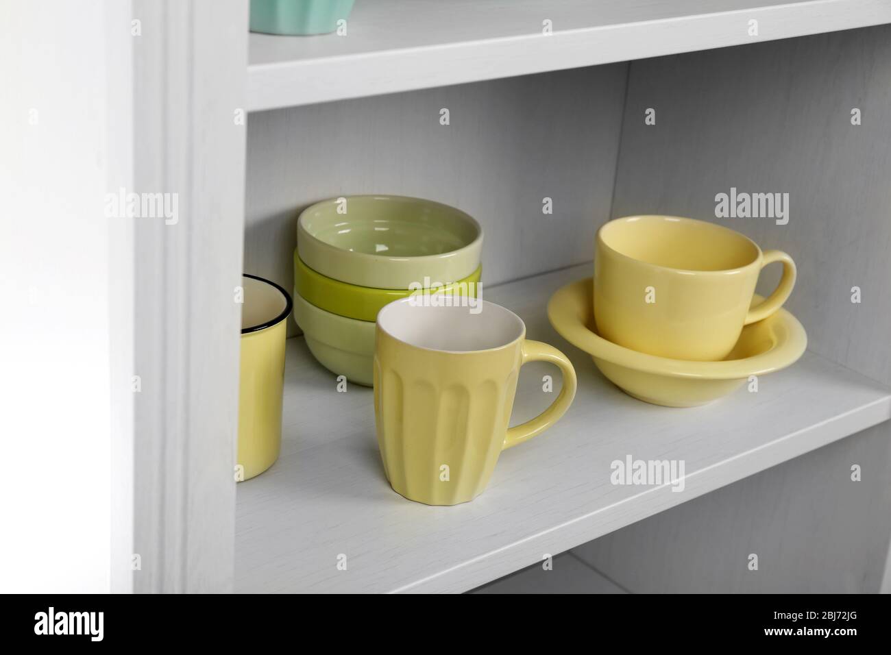 Dishes in cupboard in the kitchen Stock Photo