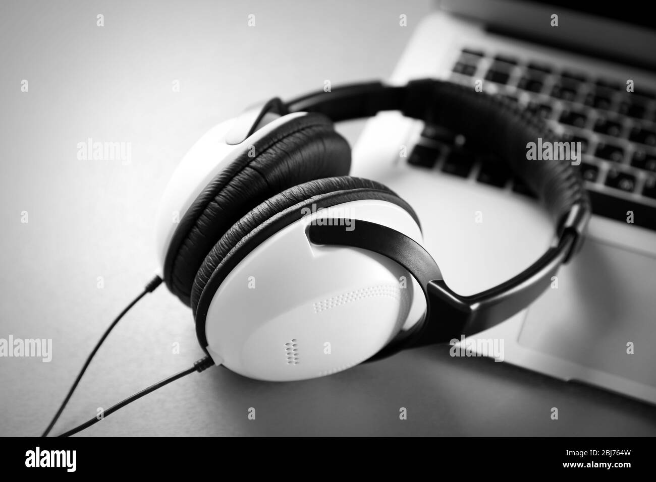 Headphones on laptop computer Black and White Stock Photos & Images - Alamy