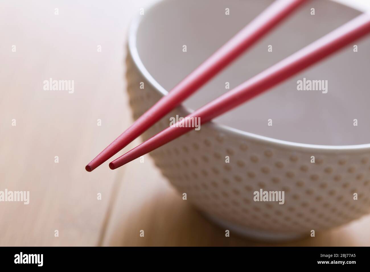 Chopsticks on bowl Stock Photo