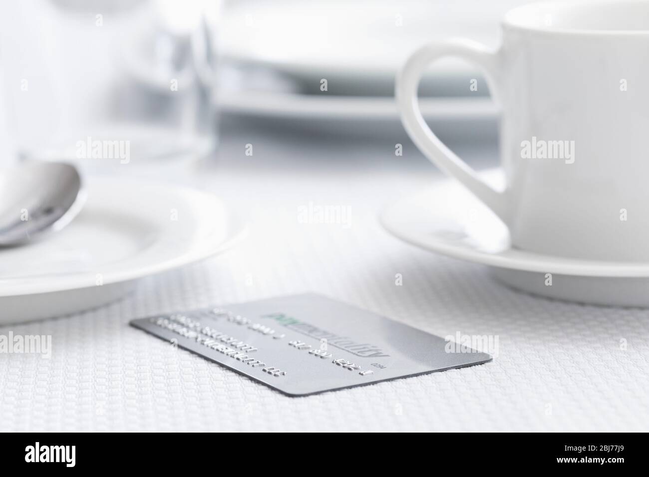 Credit card on restaurant table Stock Photo
