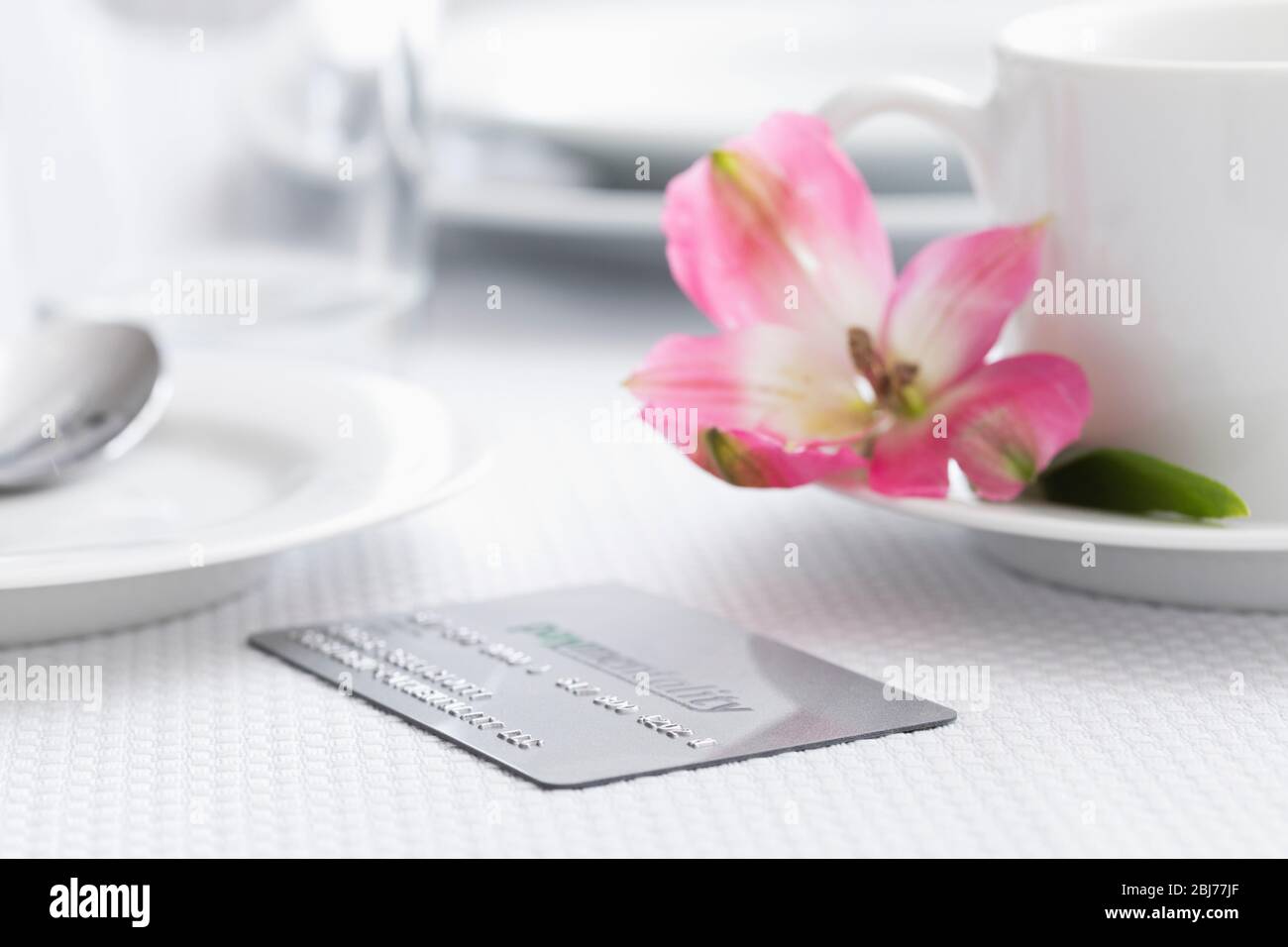 Credit card on restaurant table Stock Photo