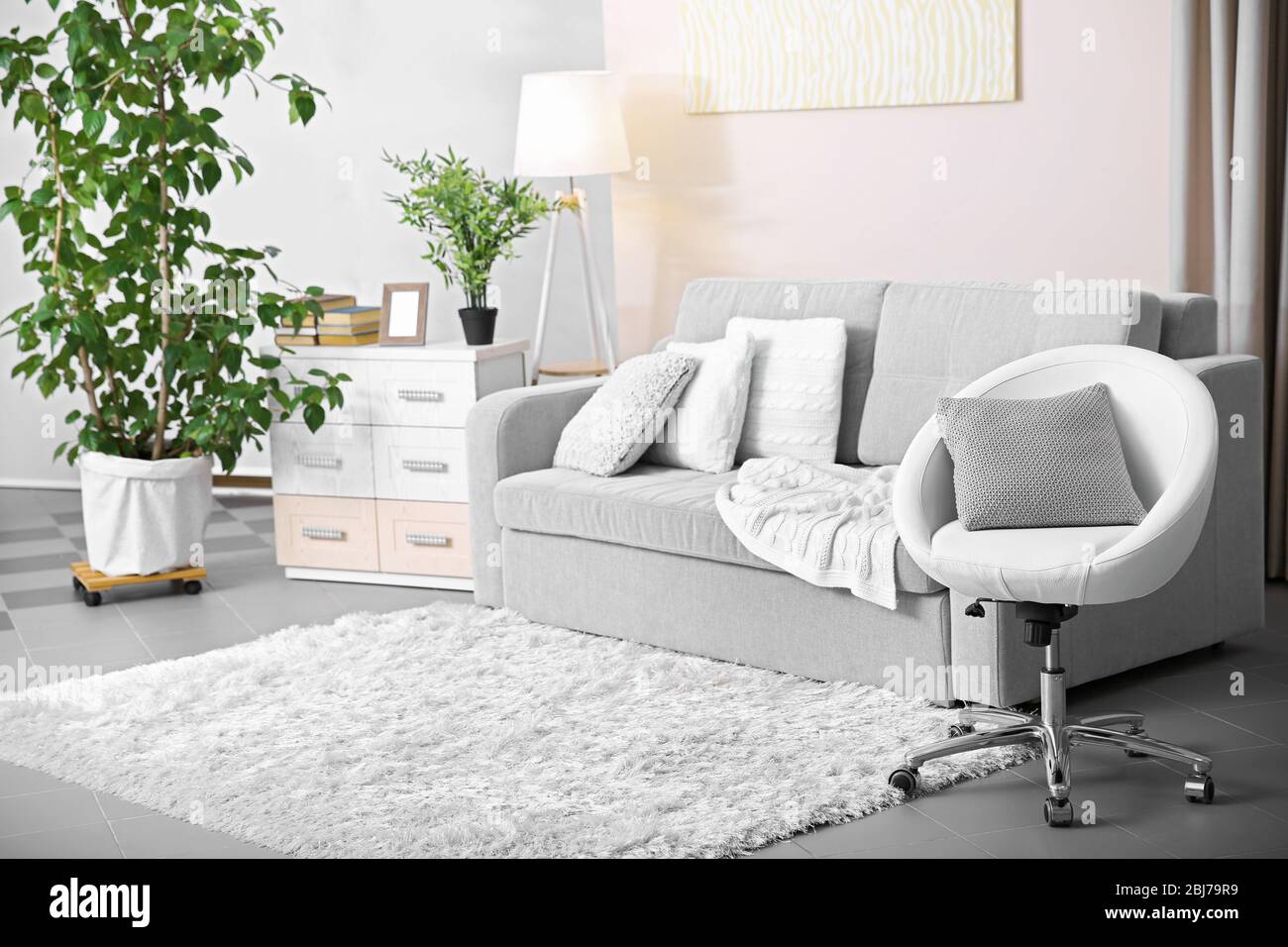 Living room design with armchair and sofa Stock Photo - Alamy