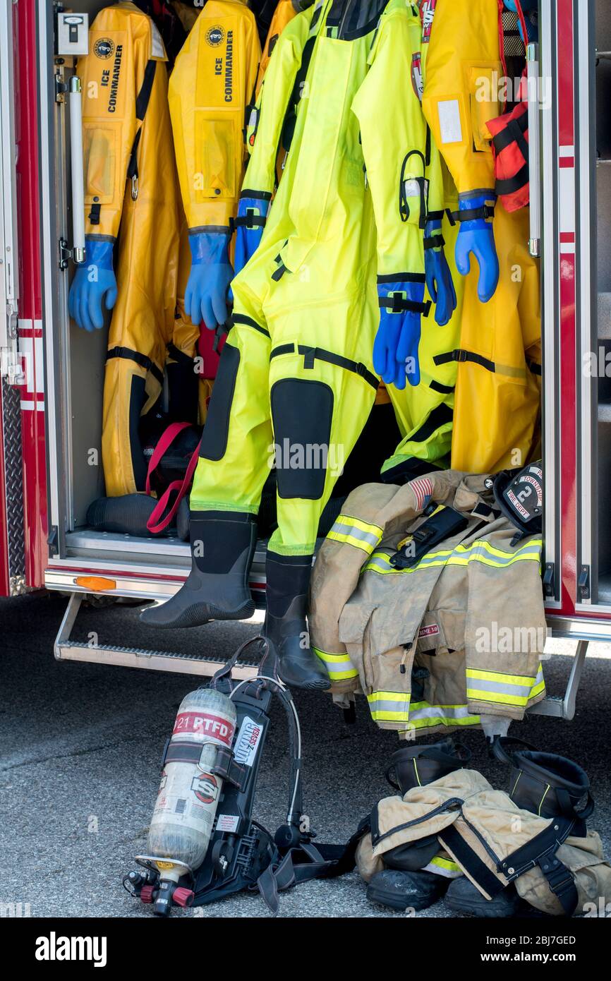 Protective gear for fire fighters and first responders on a rack inside a fire truck Stock Photo
