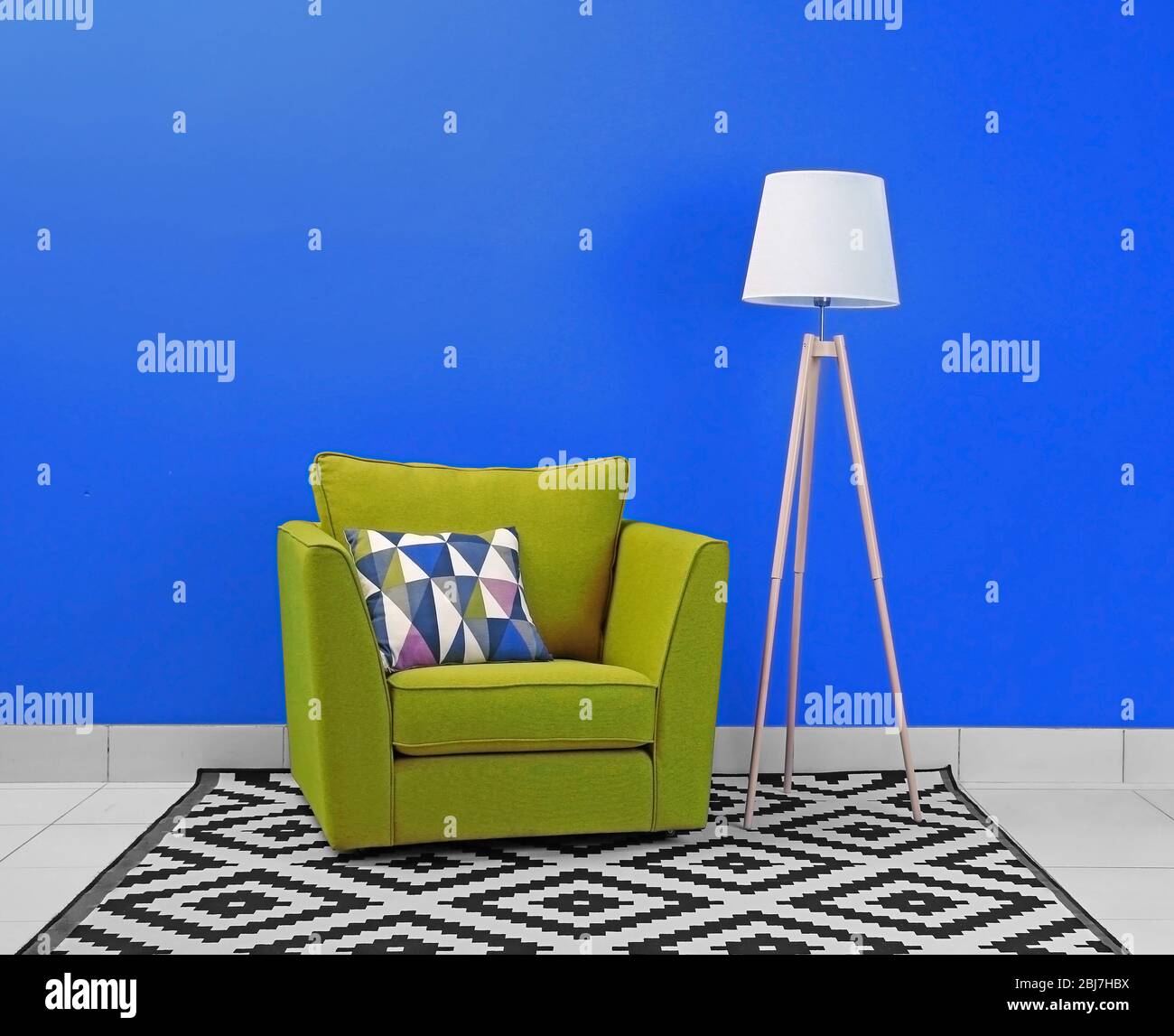 Modern interior of room with armchair on blue wall background Stock