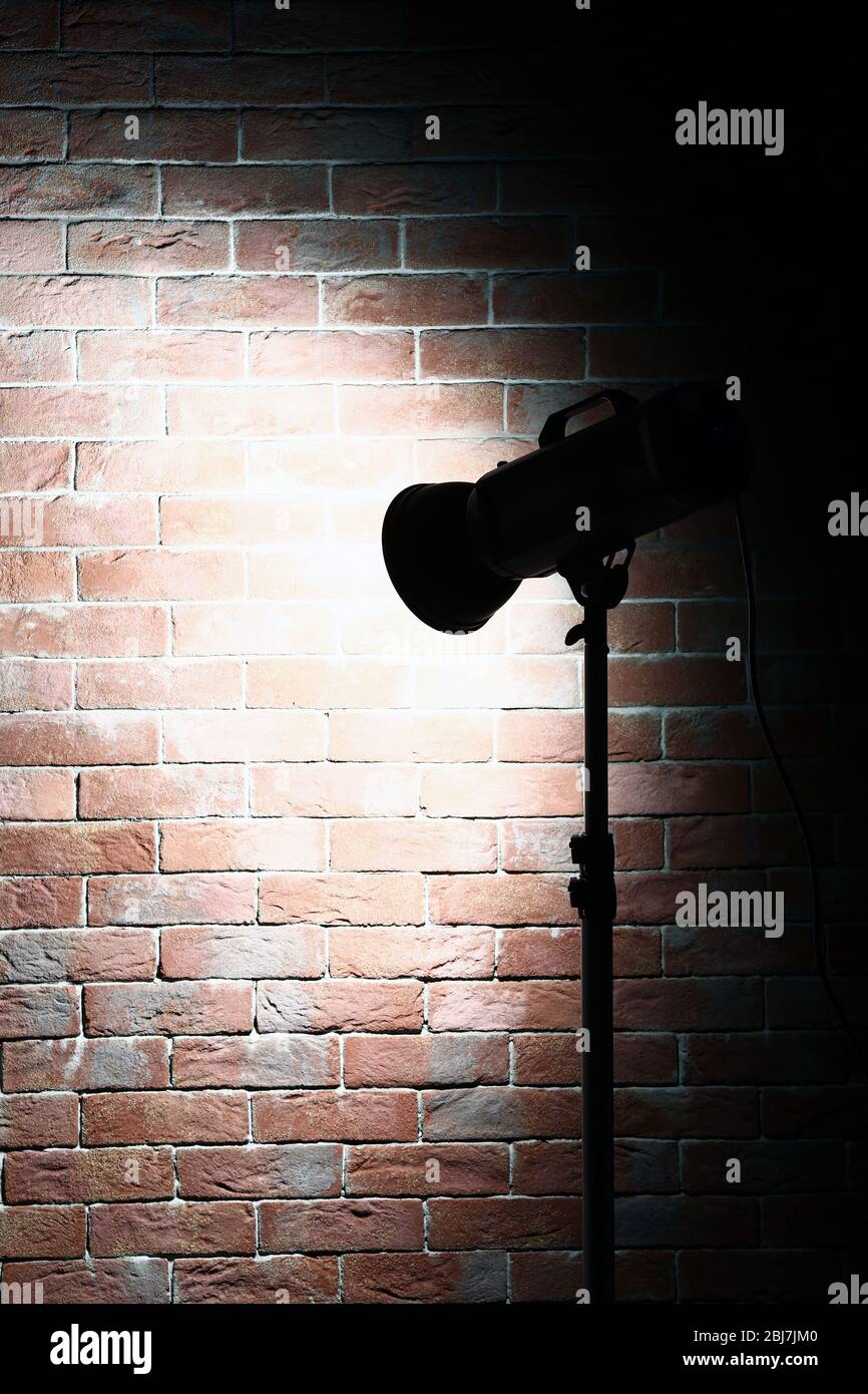 Studio light flash on brick wall background Stock Photo Alamy