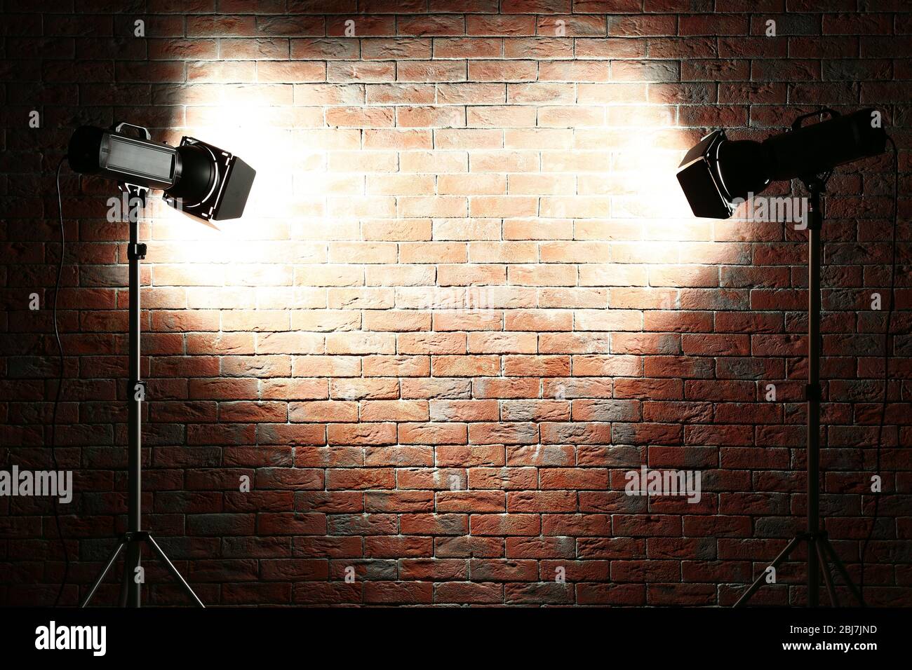 Studio light flashes on brick wall background Stock Photo - Alamy