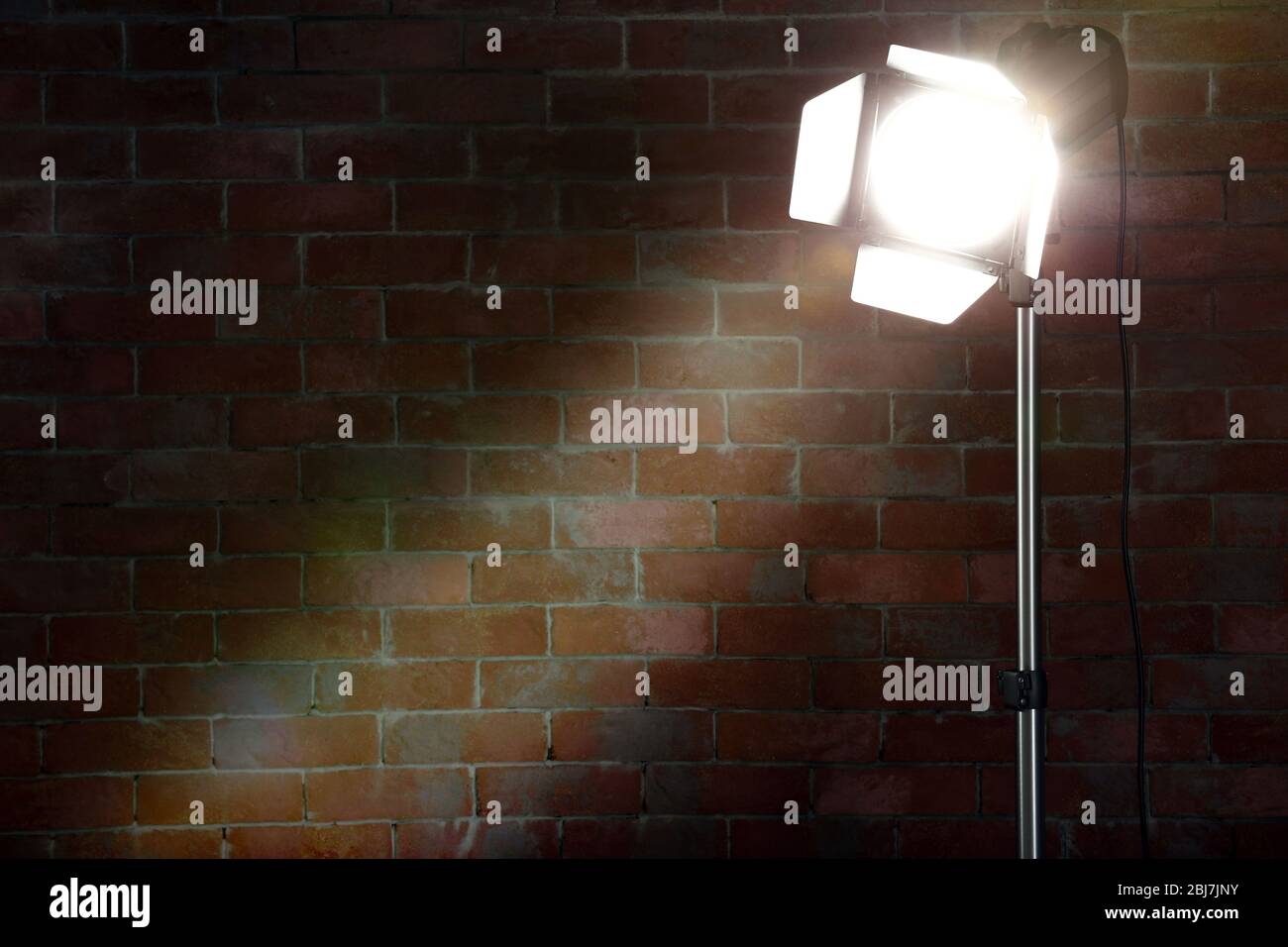 Studio light flash on brick wall background Stock Photo Alamy