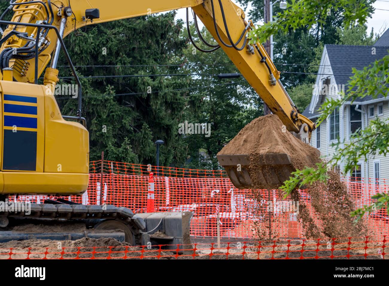 Front end loader is digging on a new construction site in a busy city