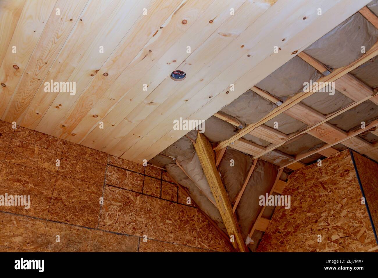 Attic with for fiberglass thermal insulation frame house in process of construction Stock Photo