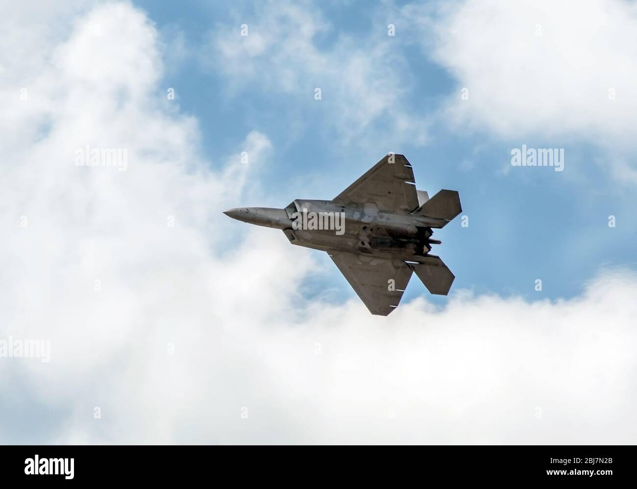 Large fighter jet in the sky flies over a Michigan town Stock Photo Alamy