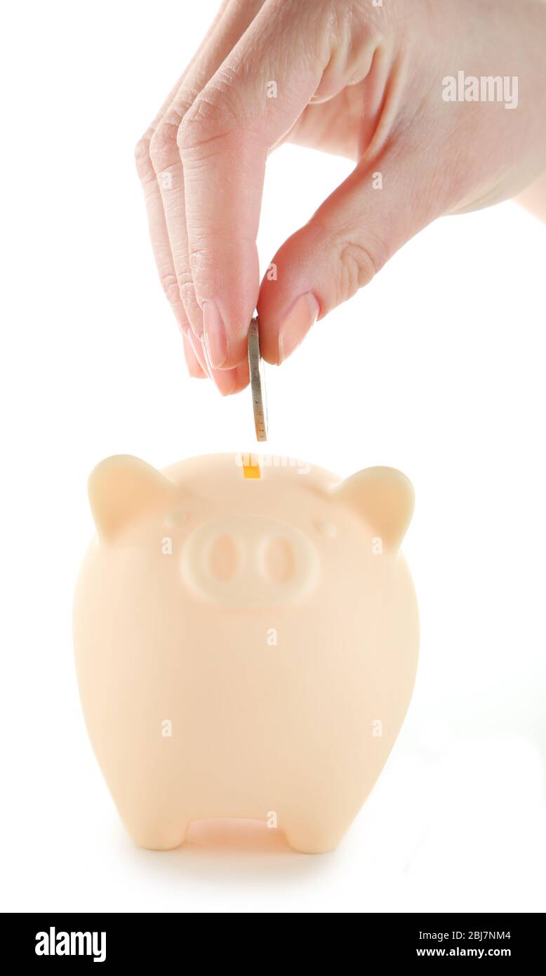 Female hand putting coin into piggy bank isolated on white Stock Photo ...