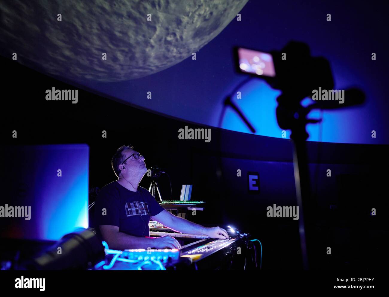 Bochum, Germany. 28th Apr, 2020. The musician Stefan Erbe plays a concert under the dome of the planetarium to present his new CD 'Nachtlichter'. Since the event originally planned for May 2nd cannot take place in front of spectators due to the corona epidemic, he recorded the concert with several cameras in advance and wants to make it available on the Internet as an online stream for the release of his 30th studio album at the time of the planned concert. Credit: Bernd Thissen/dpa/Alamy Live News Stock Photo