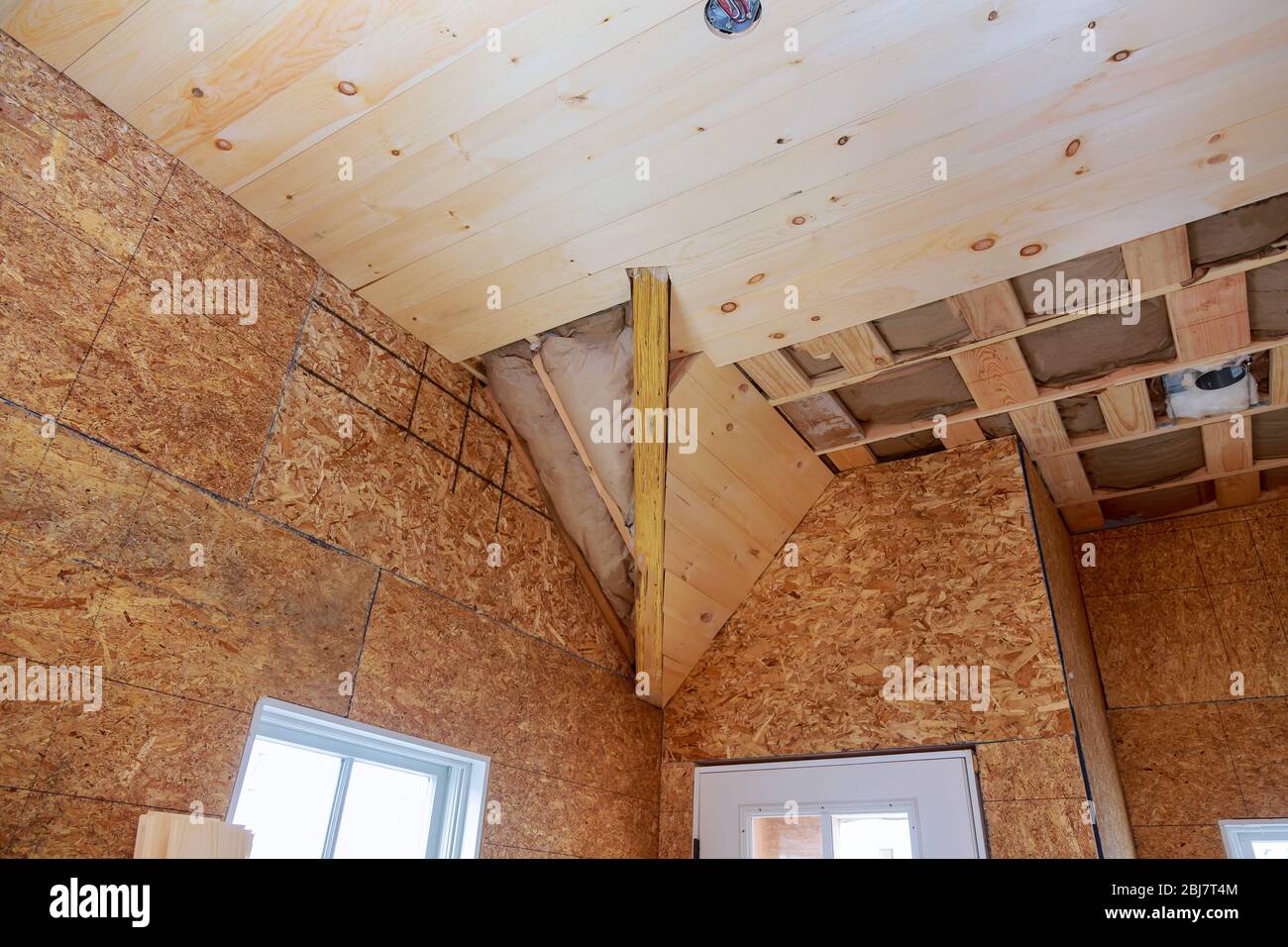 House roof with glass wool fiberglass thermal insulation house under construction home in interior home Stock Photo