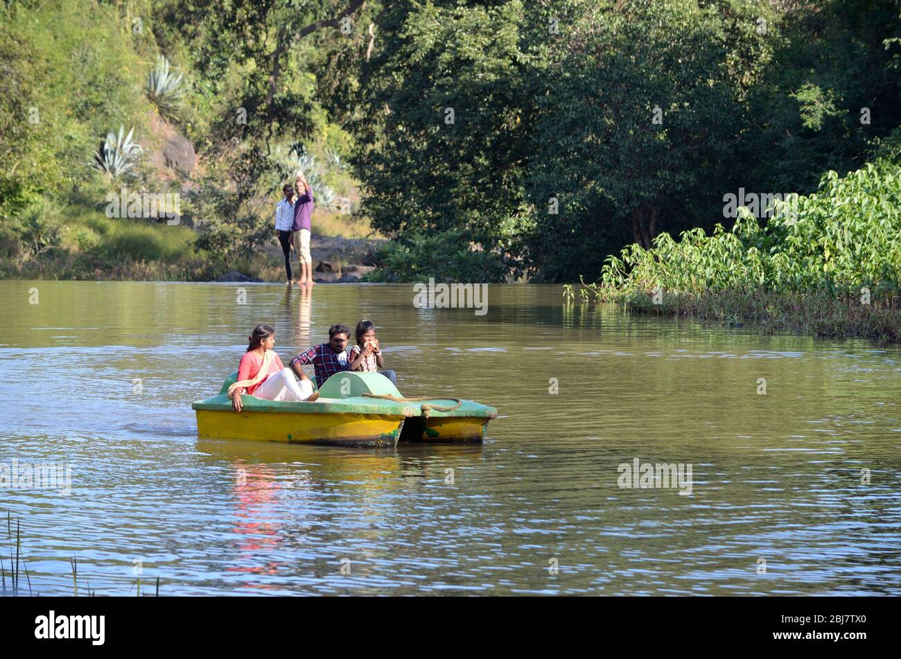 Tourists travelling on boat around lake in Kalvarayan Hills, Tamilnadu, India Stock Photo
