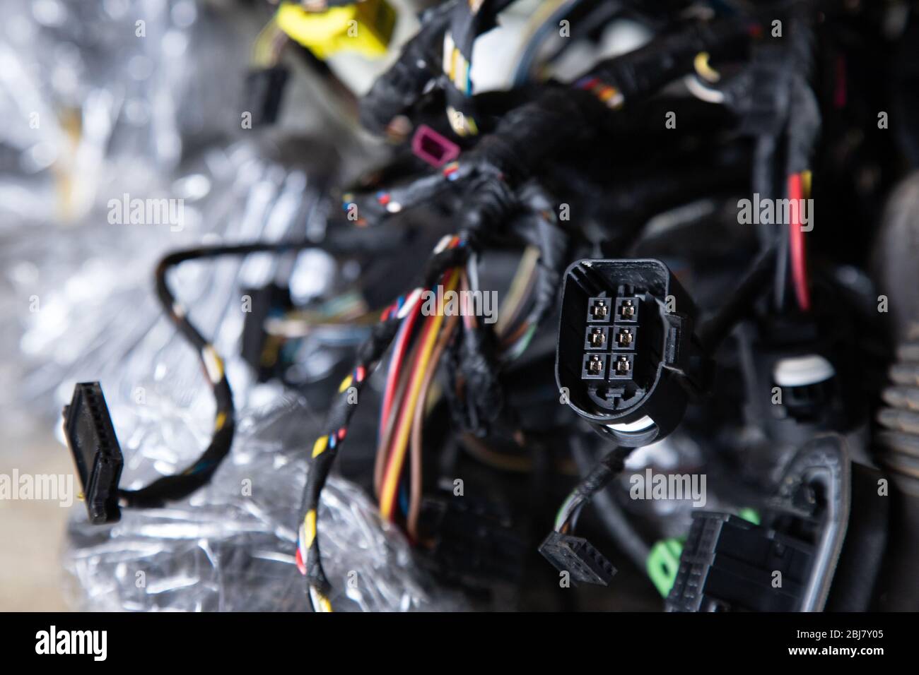Close up of the engine control unit of the car, multicolored wires plug ...