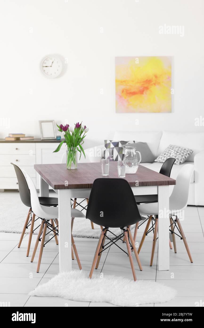 Modern Living Room Furniture Set With Table And Chairs Bouquet Of Beautiful Purple Tulips On The Table Stock Photo Alamy