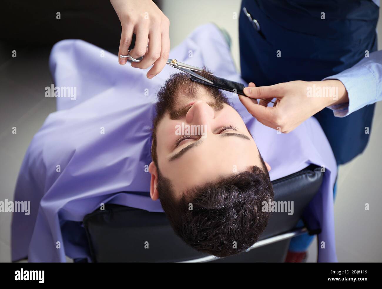 Professional hairdresser cutting beard with scissors Stock Photo Alamy