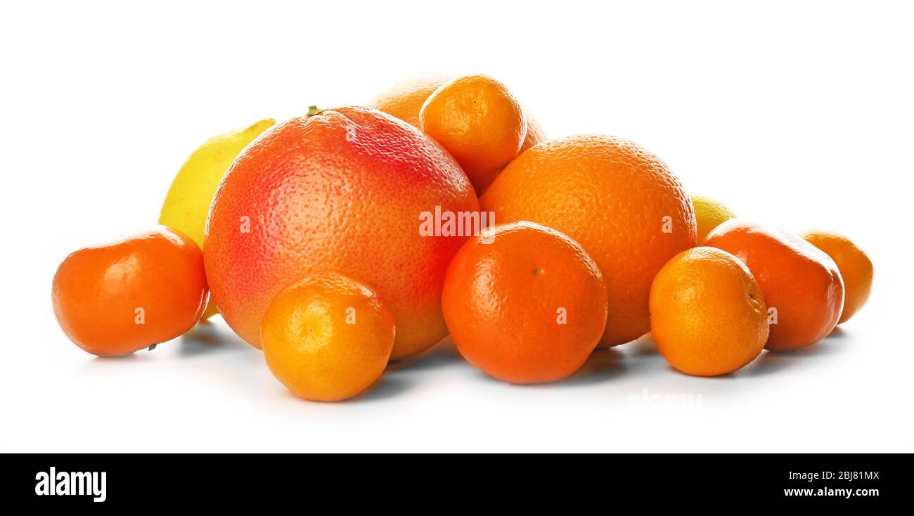 A heap of mixed citrus fruit including a grapefruit, oranges, lemons, clementines, tangerines, limes and a pomelo fruit isolated on a white background Stock Photo