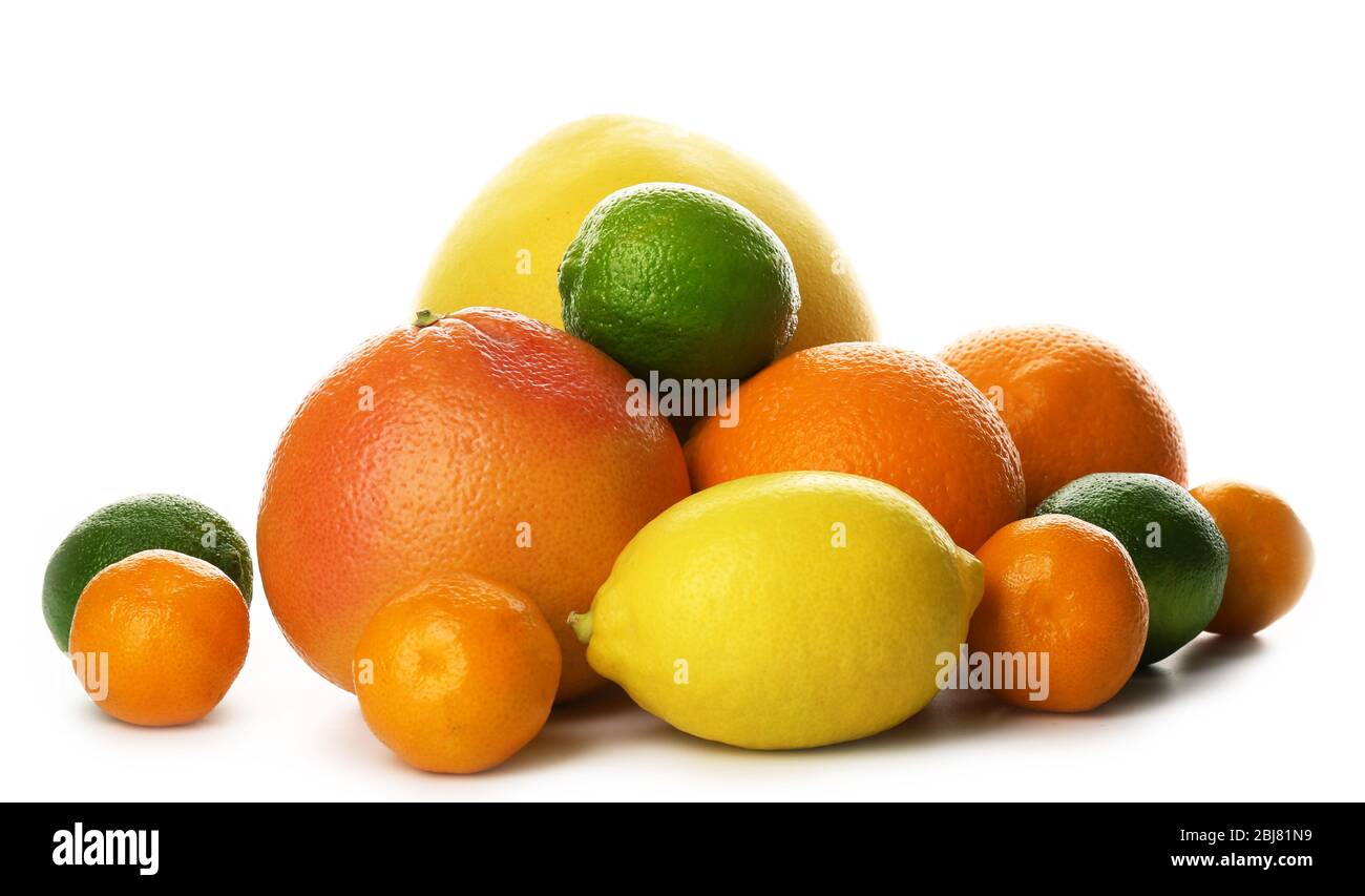 A heap of mixed citrus fruit including a grapefruit, oranges, lemons, clementines, tangerines, limes and a pomelo fruit isolated on a white background Stock Photo