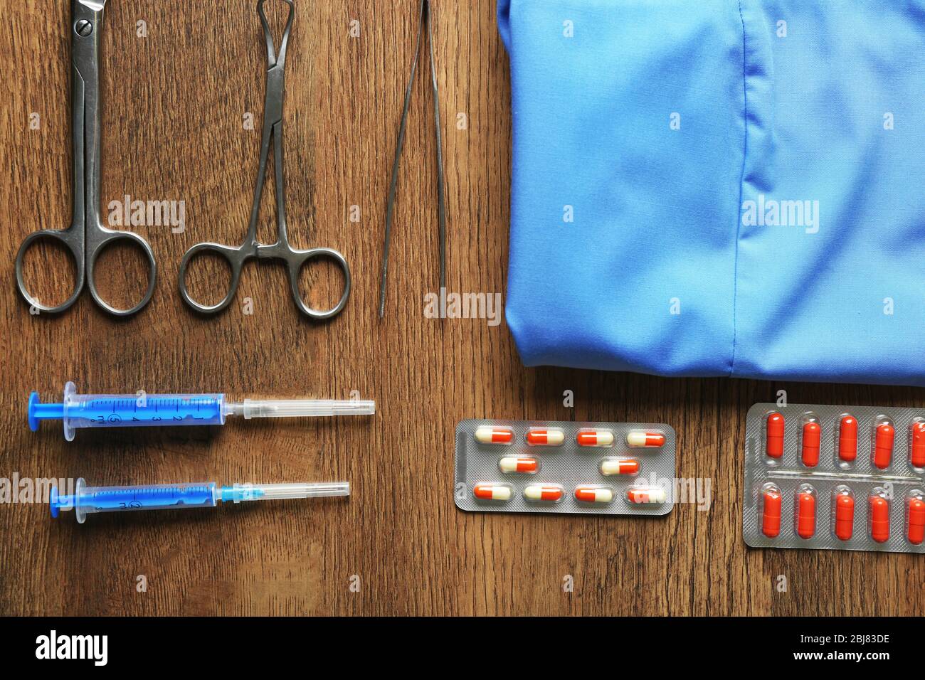 Doctor table with medicines and uniform, top view Stock Photo - Alamy