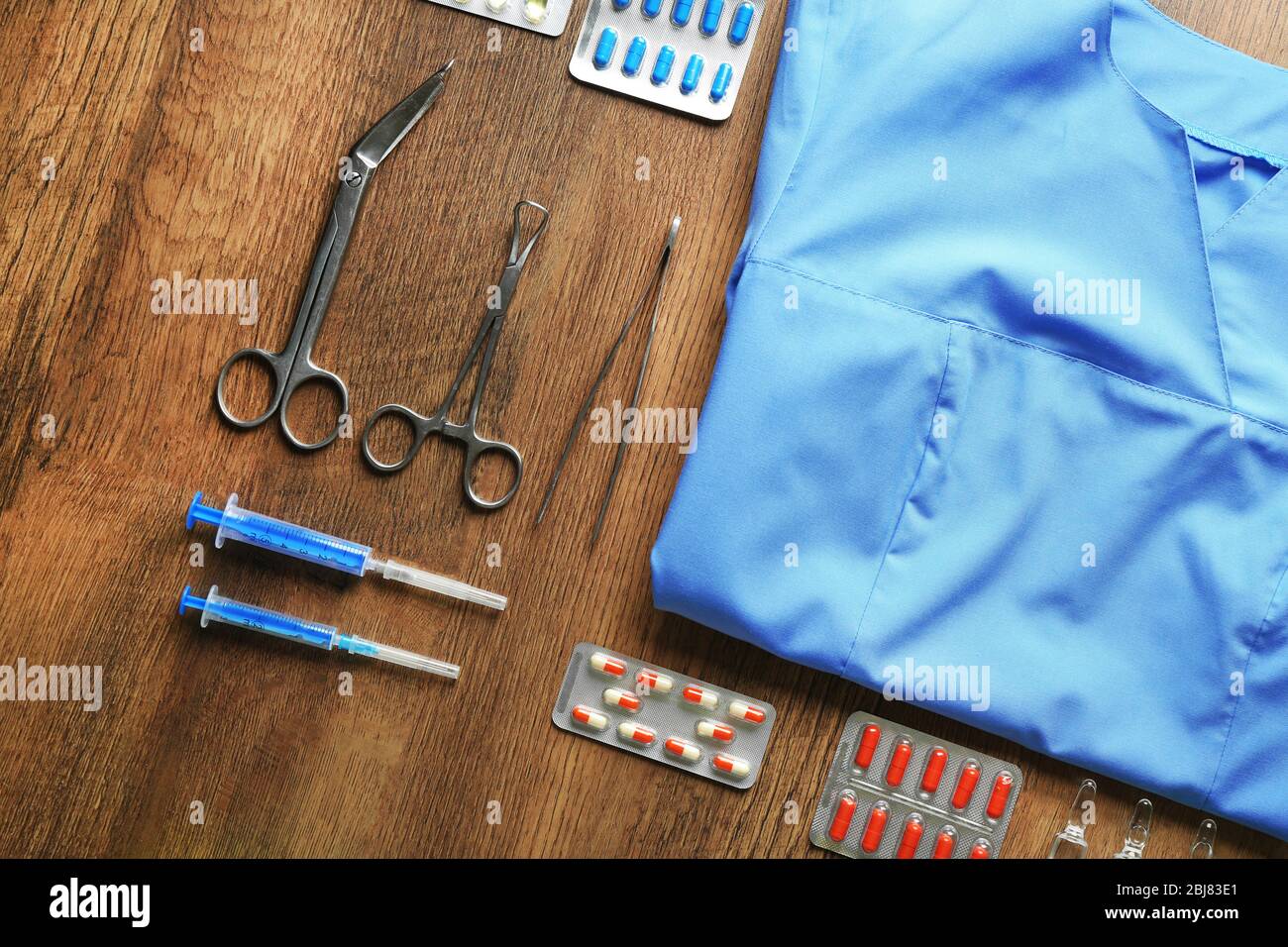 Doctor table with medicines and uniform, top view Stock Photo - Alamy