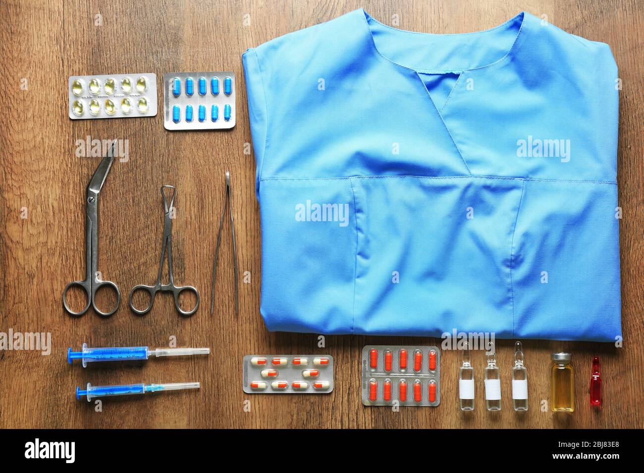 Doctor table with medicines and uniform, top view Stock Photo - Alamy