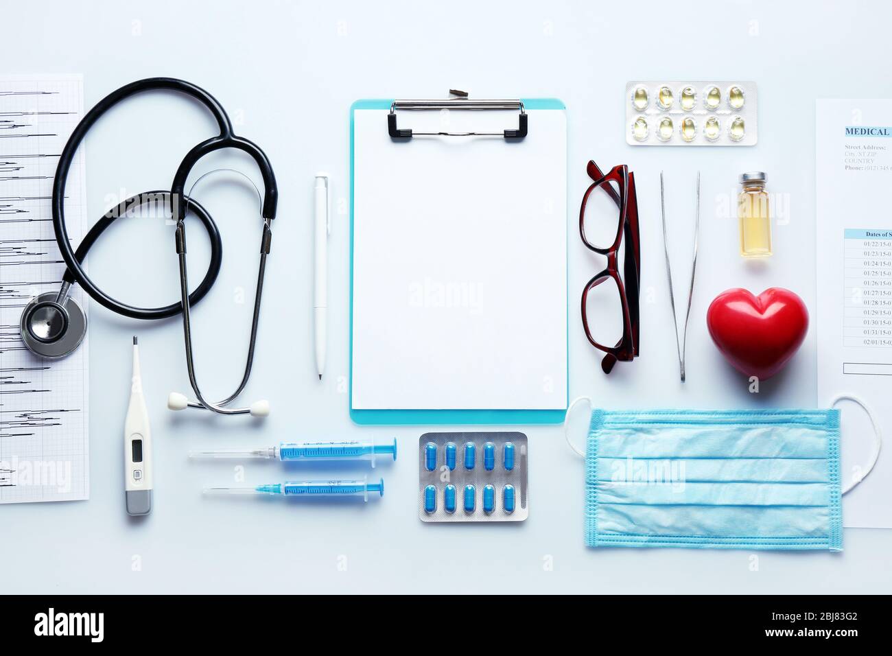 Doctor table with medicines, stethoscope and glasses, top view Stock ...