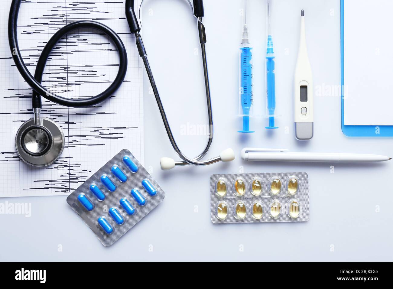 Doctor table with medical items, top view Stock Photo - Alamy