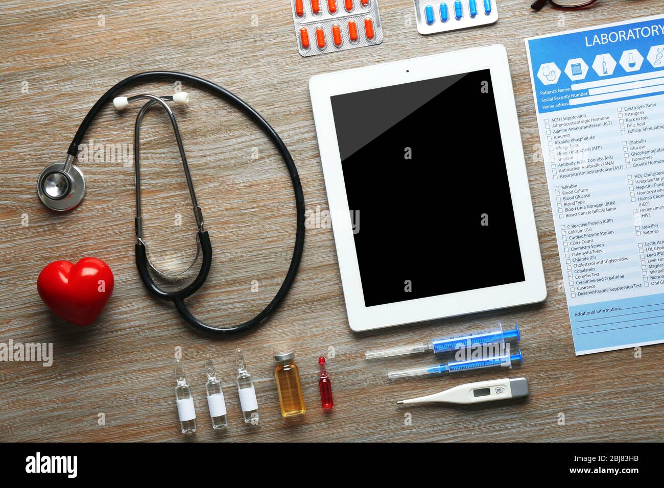 Doctor table with medicines and tablet, top view Stock Photo - Alamy