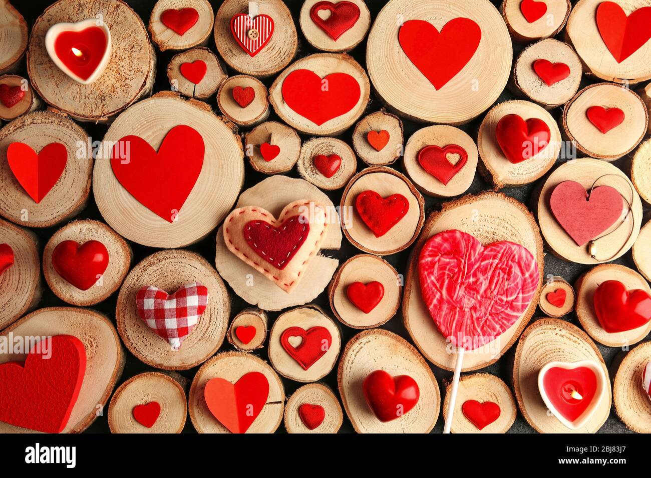 Valentine's Day concept. Different colourful hearts on wooden stumps background Stock Photo