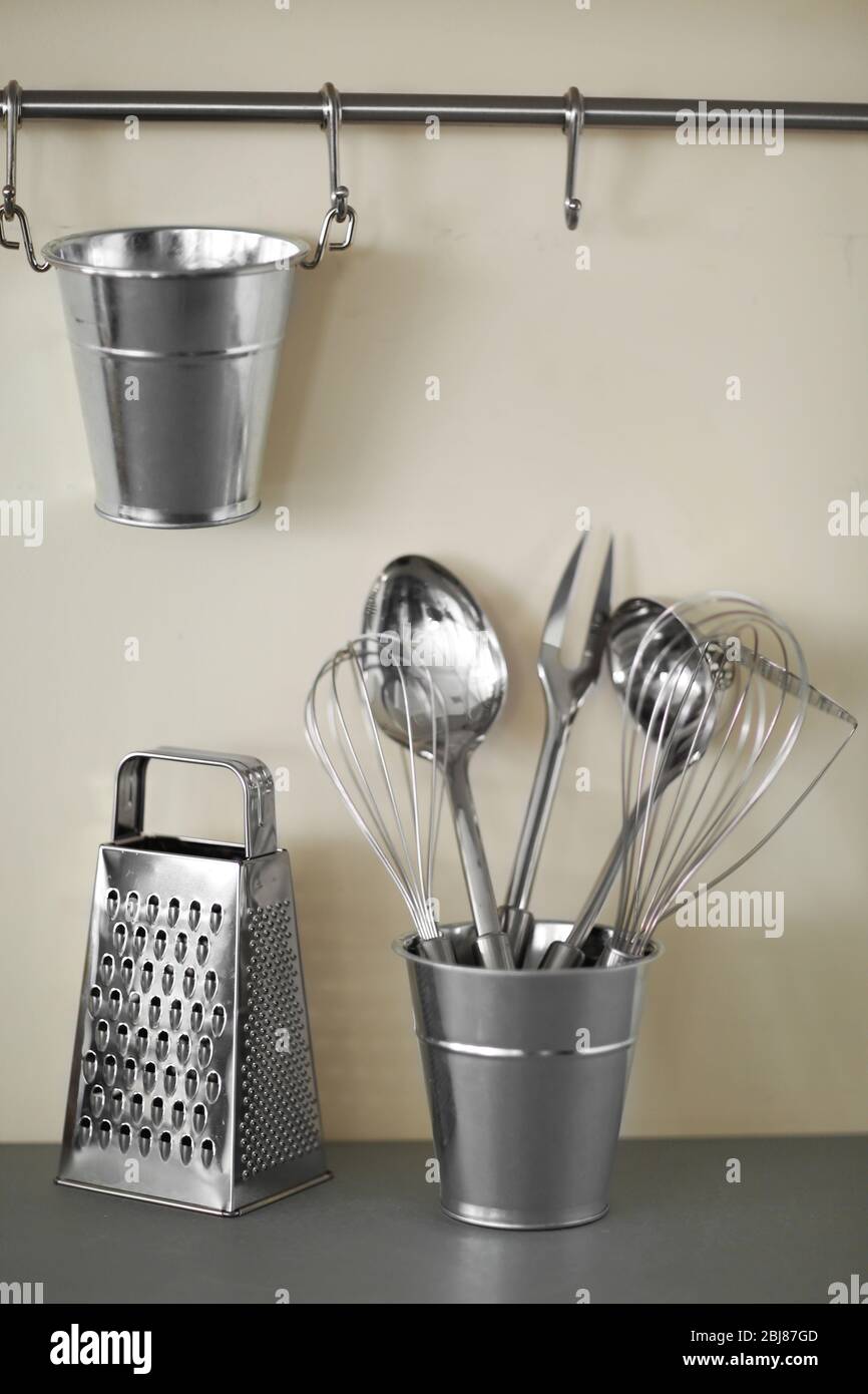 https://c8.alamy.com/comp/2BJ87GD/set-of-metal-kitchen-utensils-in-bucket-on-a-table-2BJ87GD.jpg