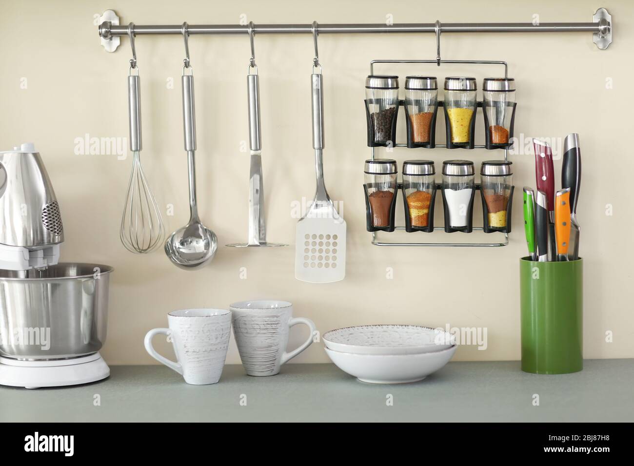 Utensils on metal rack in commercial kitchen Stock Photo - Alamy