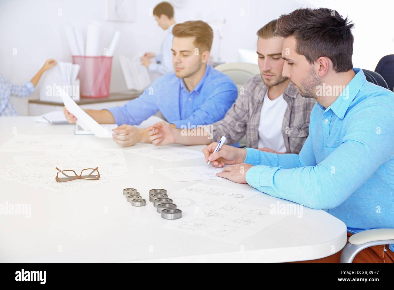 Engineers and bearings on table Stock Photo