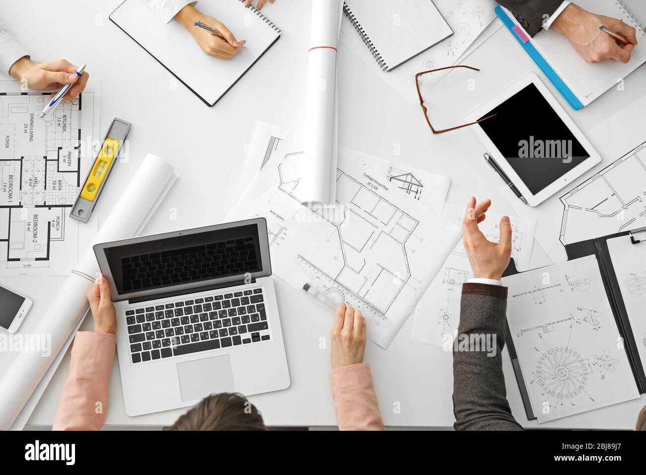 Team of professional engineers working with blueprints Stock Photo - Alamy